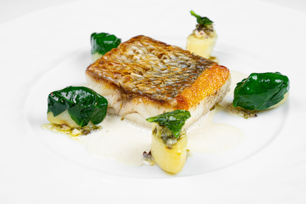 Grilled ‘scale-on’ sea bass with flavours of the sea